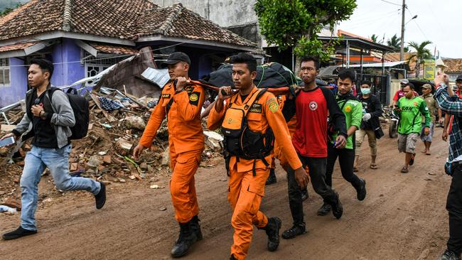 The body of a victim is retrieved in Rajabasa in Lampung, South Sumatra. Picture: AFP