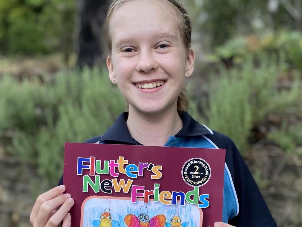 Lydia Milne holding her published book.