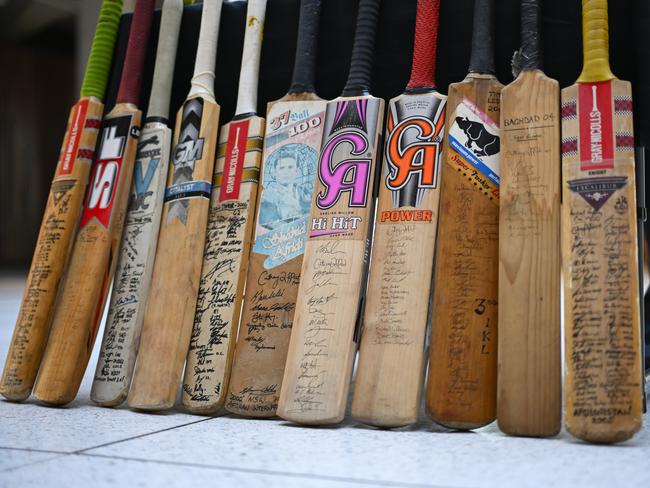 CANBERRA, AUSTRALIA, NewsWire Photos. APRIL 22, 2025: Former SAS Solider Harry Moffitt donates 11 cricket bats to Director of the Australian War Memorial, Matt Anderson in Canberra. He took the bats with him on 11 duties of war and they include the signatures of some very famous people including VC winners, prime ministers, royalty, soldiers who were later killed while on duty, and others injured. Picture: NCA NewsWire / Martin Ollman