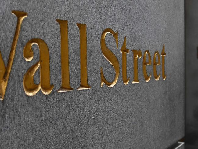 A man walks near the New York Stock Exchange (NYSE) on August 31, 2020 at Wall Street in New York City. - Wall Street stocks paused near record levels early Monday ahead of key economic data later in the week, with a newly-tweaked Dow index edging lower. The final session of a heady August opened on a lackluster note as markets await employment data and updates on the manufacturing and services sectors in the coming days. About 15 minutes into trading, the Dow Jones Industrial Average was down 0.4 percent to 28,539.83. (Photo by Angela Weiss / AFP)