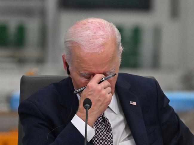 US President Joe Biden reacts while attending the Lobito Corridor Trans-Africa Summit at the Carrinho Food Processing Factory near Benguela on December 4, 2024. (Photo by ANDREW CABALLERO-REYNOLDS / AFP)