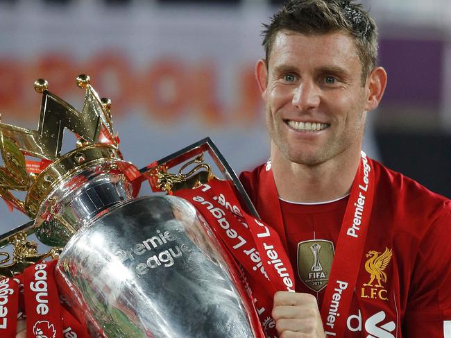 Liverpool's English midfielder James Milner poses with the Premier League trophy during the presentation following the English Premier League football match between Liverpool and Chelsea at Anfield in Liverpool, north west England on July 22, 2020. - Liverpool on Wednesday lifted the Premier League trophy at the famous Kop stand at Anfield after their final home game of the season. With no fans able to attend due to the COVID-19 coronavirus pandemic, Liverpool said the idea for the trophy lift was to honour the club's fans, but Liverpool manager Jurgen Klopp urged fans to respect social distancing measures, after thousands gathered around the club's stadium and in the city centre following their coronation as champions last month. (Photo by PHIL NOBLE / POOL / AFP) / RESTRICTED TO EDITORIAL USE. No use with unauthorized audio, video, data, fixture lists, club/league logos or 'live' services. Online in-match use limited to 120 images. An additional 40 images may be used in extra time. No video emulation. Social media in-match use limited to 120 images. An additional 40 images may be used in extra time. No use in betting publications, games or single club/league/player publications. /