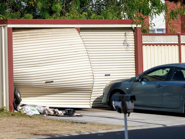 A garage door was damaged during a violent home invasion. Picture: David Geraghty