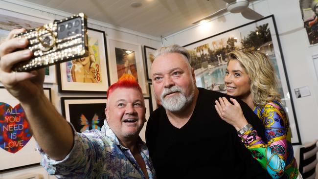 Kyle Sandilands celebrates at his friend Darren Lyons’ photography gallery in Port Douglas in far north Queensland. Sandilands is pictured Darren Lyon and his partner Tegan Kynaston. Picture: Sean Davey