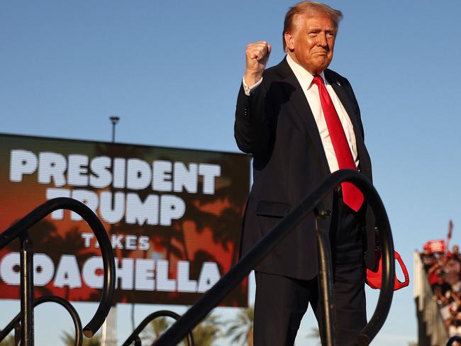 COACHELLA, CALIFORNIA - OCTOBER 12: Republican presidential nominee, former U.S. President Donald Trump gestures while walking onstage for a campaign rally on October 12, 2024 in Coachella, California. With 24 days to go until election day, former President Donald Trump is detouring from swing states to hold the rally in Democratic presidential nominee, Vice President Kamala Harris' home state.   Mario Tama/Getty Images/AFP (Photo by MARIO TAMA / GETTY IMAGES NORTH AMERICA / Getty Images via AFP)