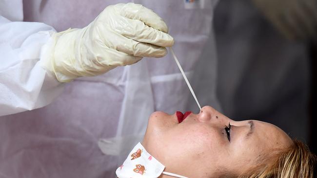 A health worker collects a swab sample from a woman for a COVID-19 test in Kathmandu. Picture: AFP