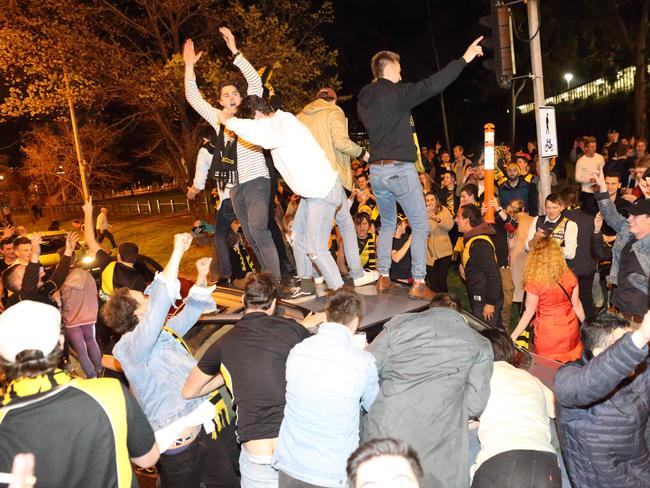 Richmond fans dance on a random car in Swan St. Picture: Patrick Herve