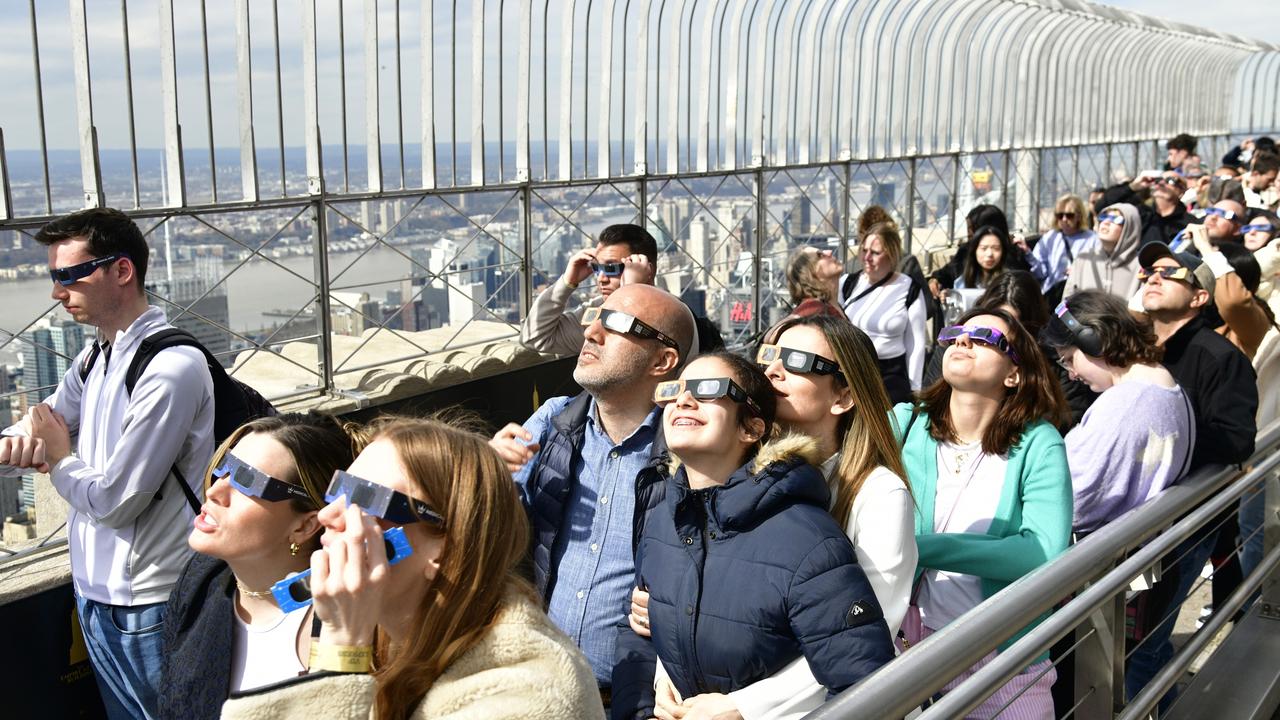 People gather to view the solar eclipse at the Empire State Building on April 08, 2024 in New York City. Picture: Eugene Gologursky/Getty Images for Empire State Realty Trust