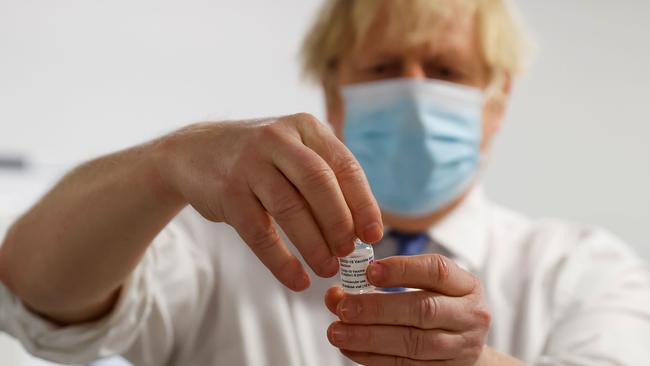 British Prime Minister Boris Johnson holds a vial of COVID-19 vaccine at Derby Arena in Derby, central Englad. Picture: AFP