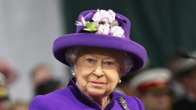 (FILES) This file photo taken on December 07, 2017 shows Britain's Queen Elizabeth II attends the Commissioning Ceremony for the Royal Navy aircraft carrier HMS Queen Elizabeth at HM Naval Base in Portsmouth, southern England on December 7, 2017.  Queen Elizabeth II's luxury lingerie maker Rigby & Peller has lost its royal warrant, an official said on January 11, 2018, after its former owner published a book revealing details of the royal bra fittings. / AFP PHOTO / POOL / Chris Jackson