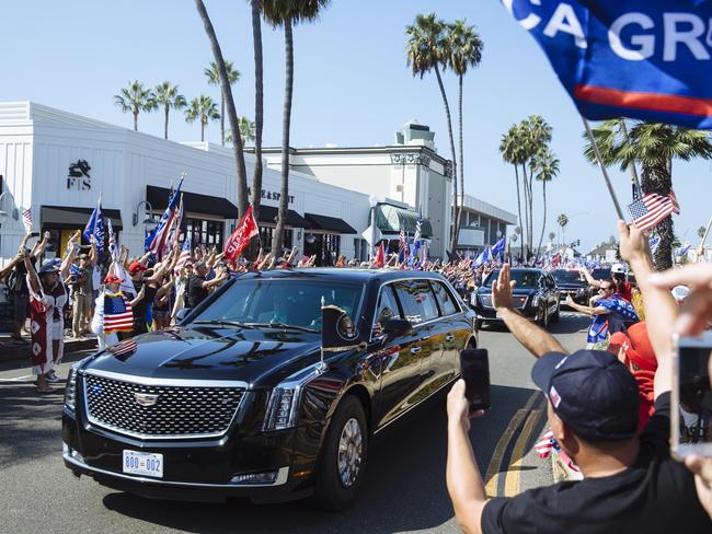 Supporters of President Donald Trump ignore police orders to stay on the footpath and rush towards his motorcade in Newport Beach, California, USA. Picture: Angus Mordant