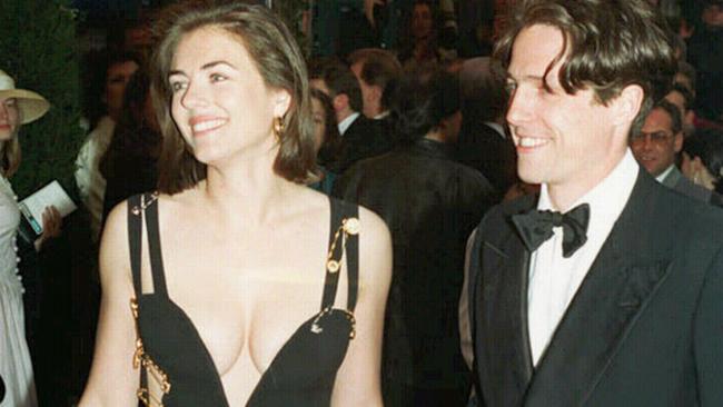 11/05/1994. Hugh Grant with actress Elizabeth Hurley (Liz Hurley), wearing a dress designed by Gianni Versace, in this Dec94 picture in London. Four weddings and a funeral. Premiere. (AP Photo/Mike Stephens)*UNITED KINGDOM OUT*