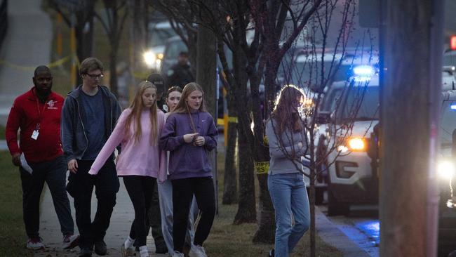 : Students are escorted from a church next to the Abundant Life Christian School and loaded on buses to be taken to a reunification centre. Picture: Scott Olson/Getty/AFP