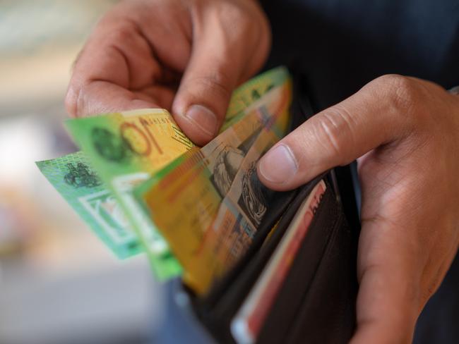 a male taking money out of the valet.