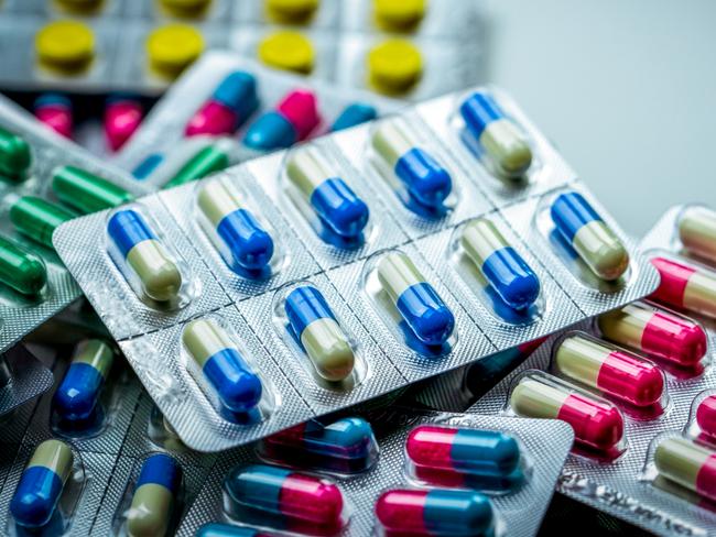 Pile of antibiotic capsule pills in blister pack. Pharmaceutical packaging. Medicine for infections disease. Antibiotic drug used in food animals at animals farm spread of antibiotic resistance