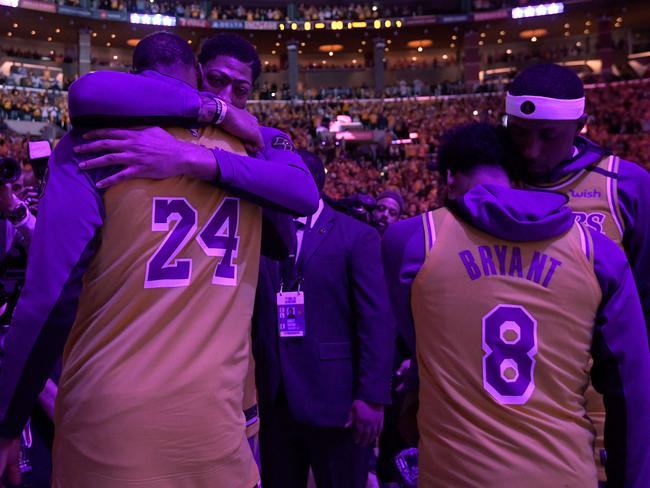 (L-R) Anthony Davis, LeBron James, Quinn Cook and Kentavious Caldwell-Pope of the Los Angeles Lakers hug during a ceremony to honour Kobe Bryant. Picture: Harry How/Getty Images/AFP