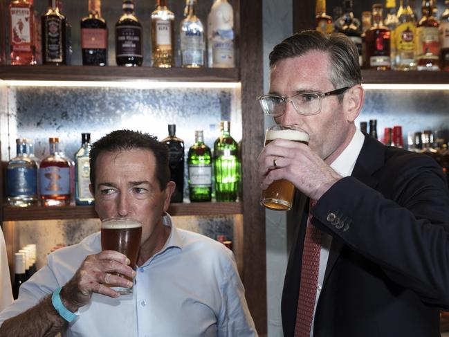 NSW Deputy Premier Paul Toole and Premier Dominic Perrottet drink a beer before speaking to the media at Watson’s Pub in Moore Park. Picture: Brook Mitchell/Getty Images