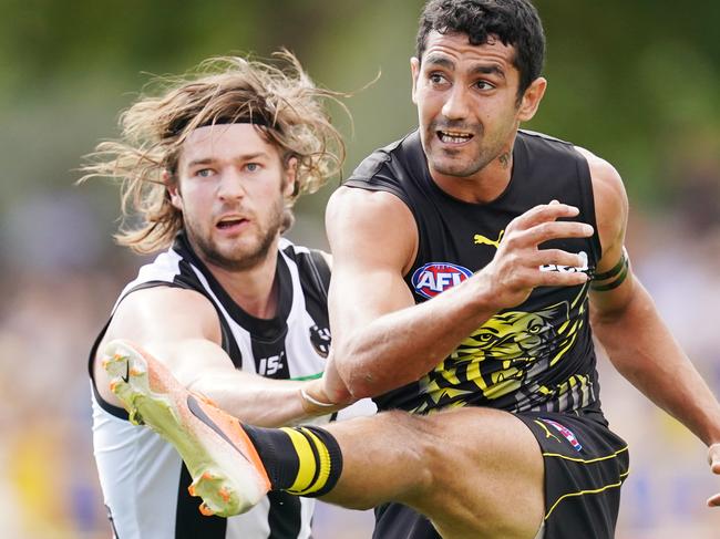 Marlion Pickett of the Tigers kicks the ball from Rupert Wills of Collingwood during the AFL Marsh Community Series pre-season match between the Richmond Tigers and the Collingwood Magpies at Norm Minns Oval in Wangaratta, Sunday, March 1, 2020. (AAP Image/Michael Dodge) NO ARCHIVING, EDITORIAL USE ONLY