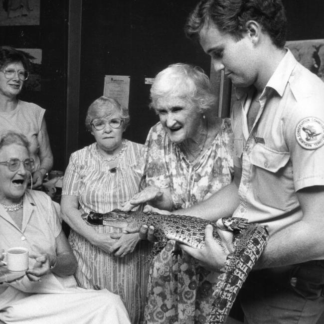 Members of the Golden Oldies Senior Club are shown a baby crocodile by a Northern Territory Conservation Commission officer. Picture: News Corp Australia