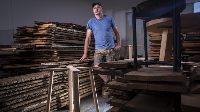 Jason Somerville overlooks recycled timbers at his furniture store in Williamstown. Picture by Wayne Taylor.