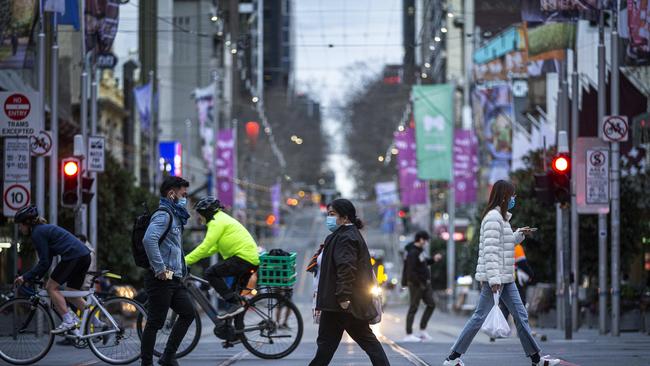 Locals don their masks in Swanston Street. Picture: Daniel Pockett