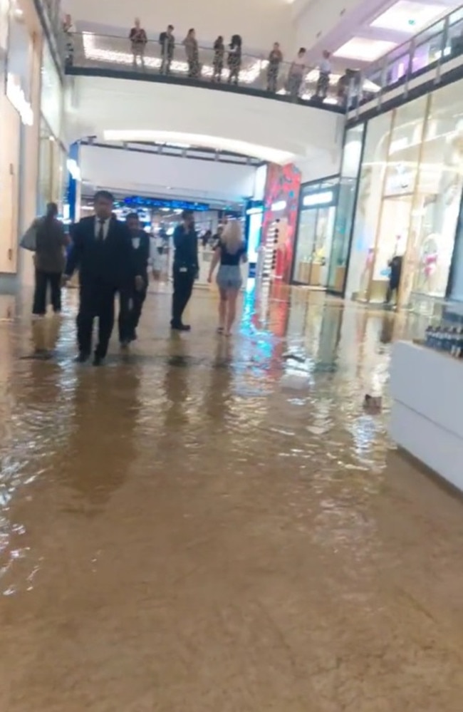 Inside the Mall of the Emirates where a security guard instructs shoppers to leave the centre.