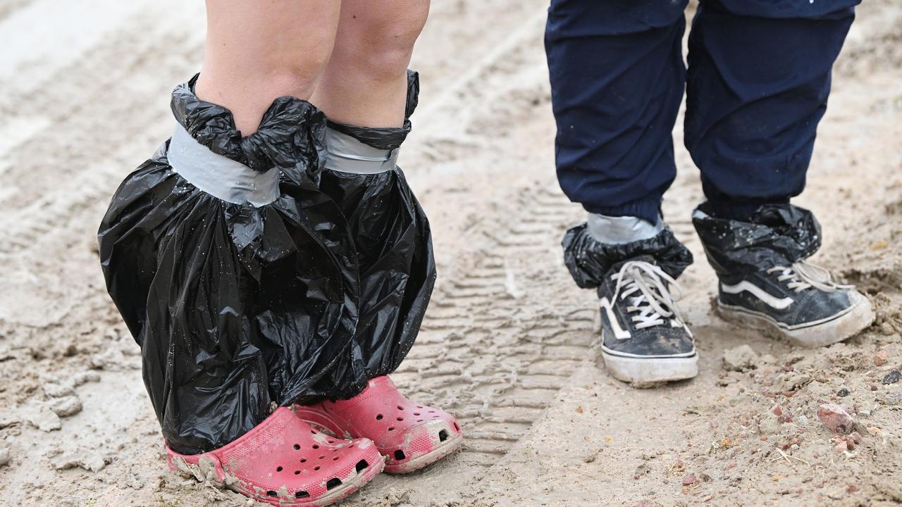 Punters had to get creative with their choice of footwear at the Birdsville races. Picture: Lyndon Mechielsen/MaxAgency