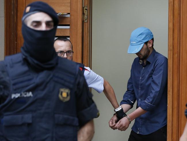 Catalan autonomous police officers detain a cuffed suspect in Ripoll during a search linked to the deadly terror attacks in Barcelona and the seaside resort of Cambrils. Picture: AFP