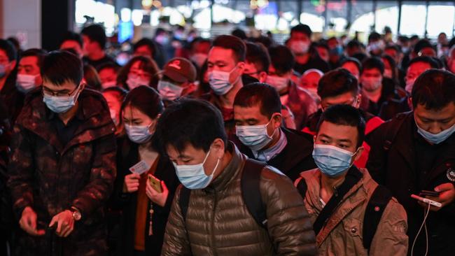 Passengers walk toward Wuhan railway station in Wuhan, China on Wednesday. Picture: AFP