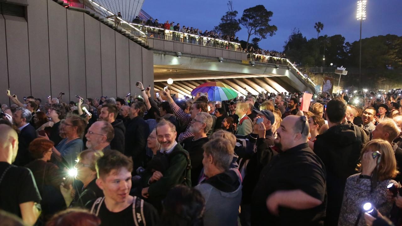Pictured outside the Sydney Opera House are protesters trying to disrupt the lights with their own torches. Picture: Christian Gilles