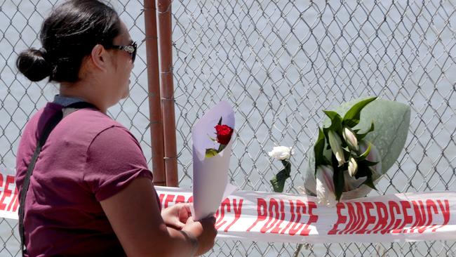 Flowers are laid at the cordon to the port in Whakatane, New Zealand in honour of victims of the White Island disaster. Picture: AAP