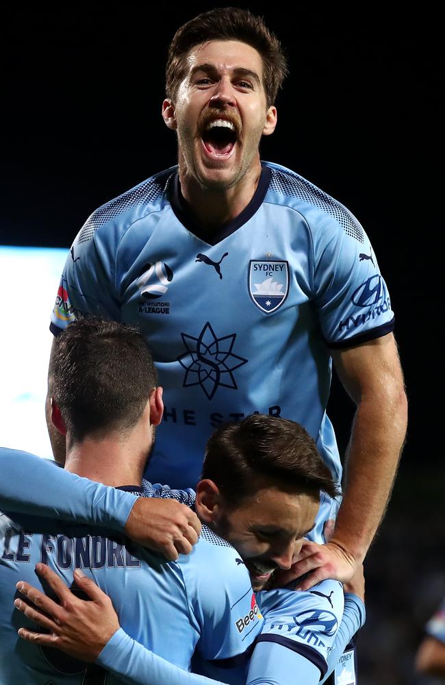 Josh Brillante celebrates with Sydney FC teammates Adam Le Fondre and Milos Ninkovic after Le Fondre scored against Melbourne Victory in Sunday’s semi-final rout. Picture: Getty Images