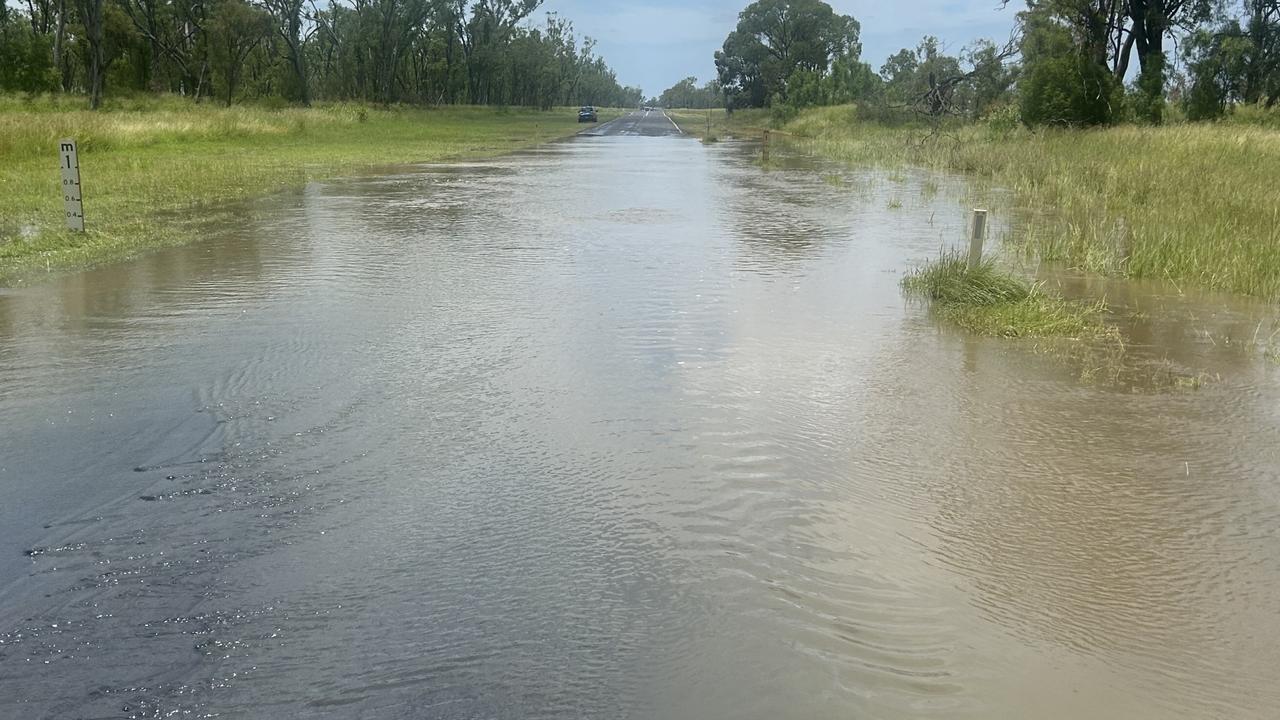 Child escapes floodwaters as alert issued for regional Qld town