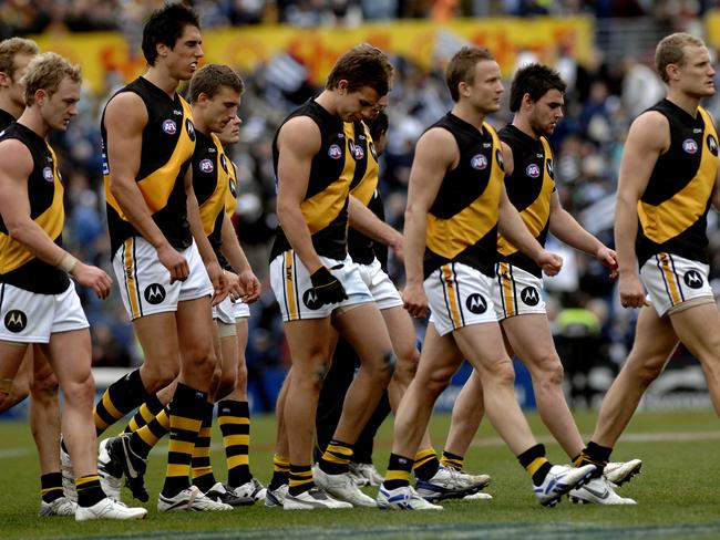 Tigers players leave the field after their 155-point thrashing by Geelong.