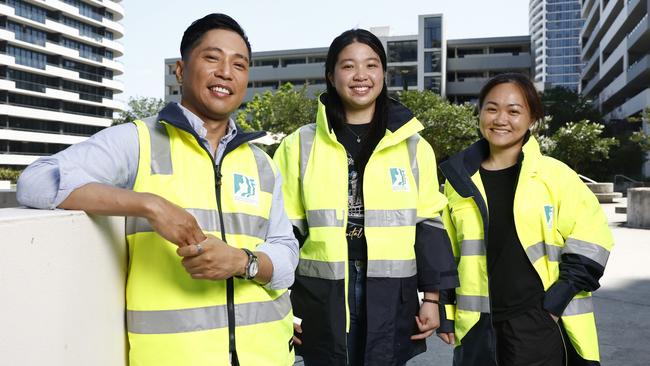 Pictured in Rhodes is local resident Ramee Florentino, with fellow locals Tiffany Zhong and Sharon Zhang. Ramee Florentino has started a neighbourhood watch group and enlisted members of the community to volunteer. Picture: Richard Dobson