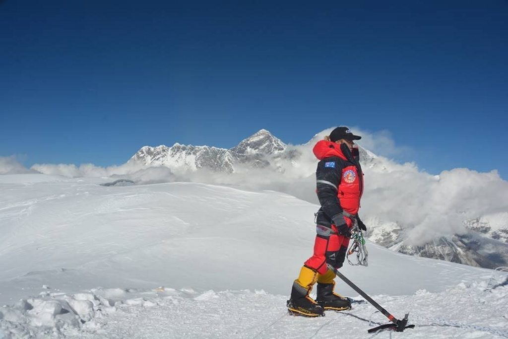 Alyssa Azar on the summit of Ama Dablam with Mount Everest rising in the background behind her. Picture: Contributed