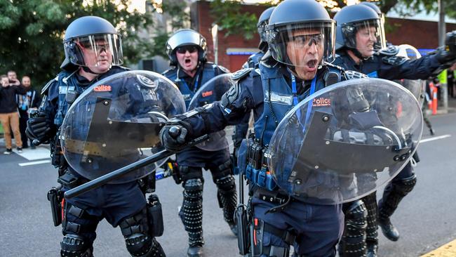 Police in riot gear charge at protesters outside a Milo Yiannopoulos speaking event. Picture: Jake Nowakowski