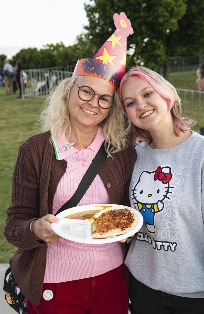 Mel (left) and Saffron Frater at the Symphony Under the Stars concert performed by the Queensland Symphony Orchestra in Queens Park Amphitheatre for Carnival of Flowers, Friday, October 4, 2024. Picture: Kevin Farmer