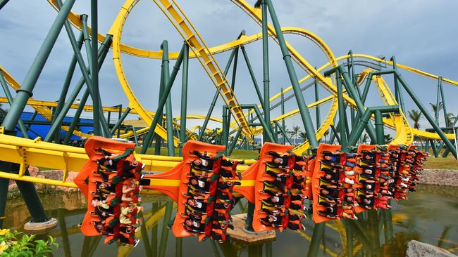 Visitors ride on a roller coaster ride at Xishuangbanna Resort in Yunnan, China.