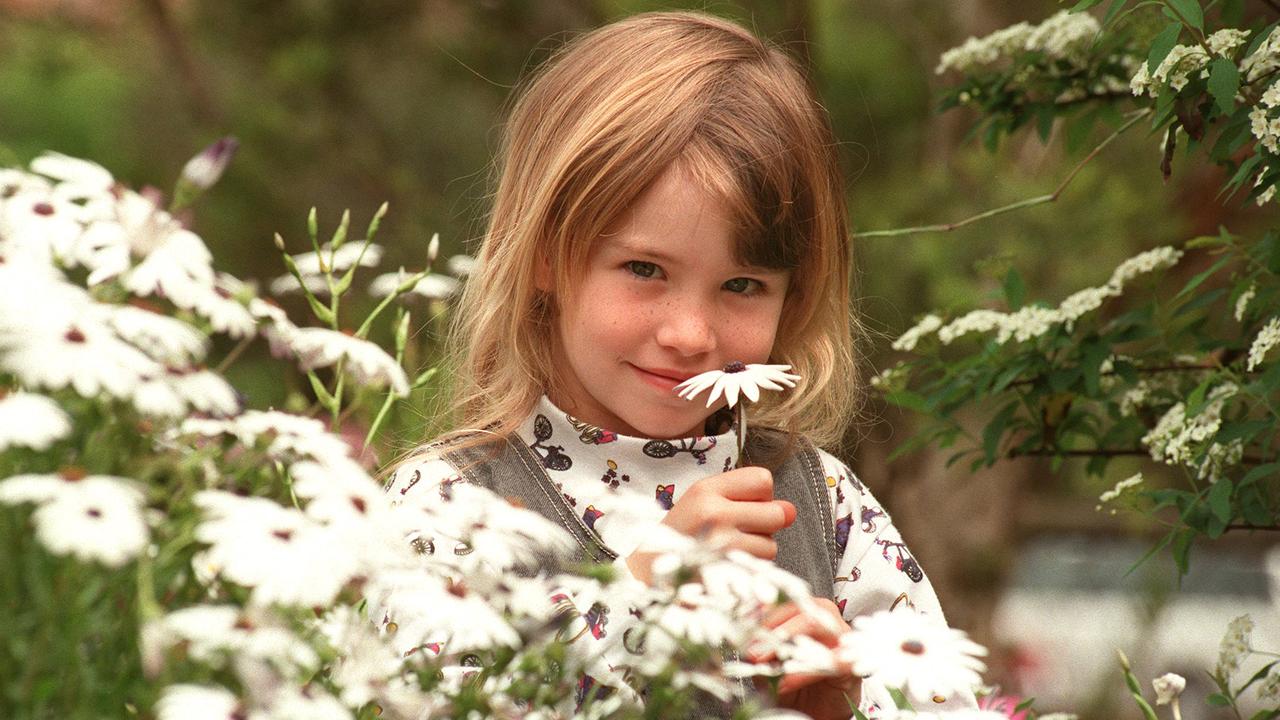 Pic Bruce/Long- Aust Carnival of Flowers at Toowoomba- 19/9/96. Samantha Fox with flower at the Toowoomba East State Preschool for their award winning display Daisies children education preschool sept 1996 fairs festivals gardening