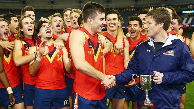 South Australia captain Luke Valente accepts the under-18 championships trophy from Luke Power after defeating Vic Metro.