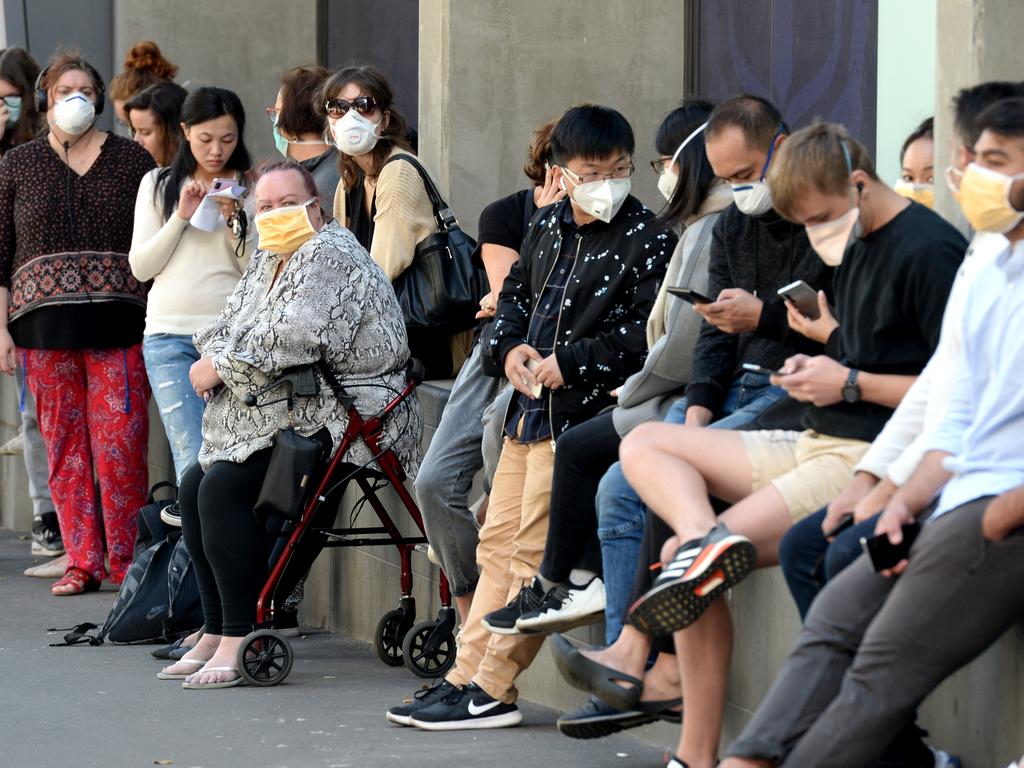 People queue outside the Royal Melbourne Hospital waiting to be tested for the coronavirus. Picture: Andrew Henshaw