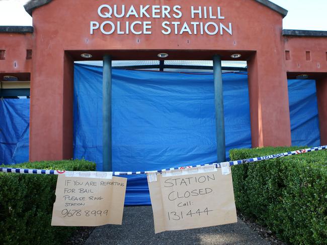 The station remains closed with signs attached to police tape informing people of numbers to contact if reporting for bail. Picture: Stephen Cooper