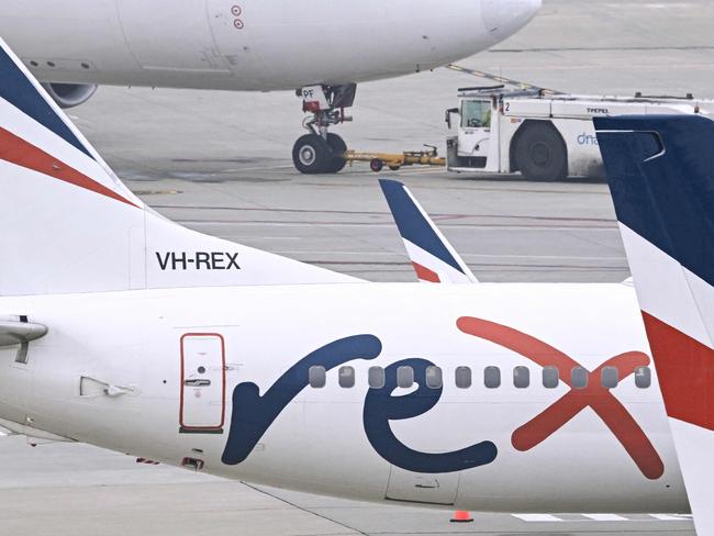 Rex Airlines Boeing 737 planes lay idle on the tarmac at Melbourne's Tullamarine Airport on July 31, 2024. The Australian regional airline Rex cancelled flights as it entered voluntary administration on July 31, leaving the fate of the country's third-largest carrier in serious doubt. (Photo by William WEST / AFP)