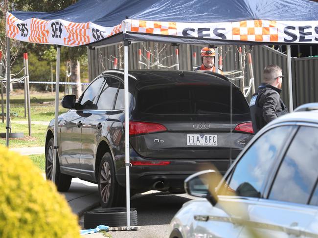 Police keep watch over the dumped Audi Q5. Picture: David Crosling