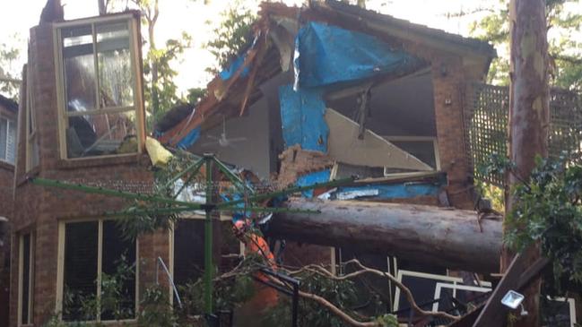 A house is crushed by a fallen tree in Sydney's northwest. Picture: Facebook NSW SES