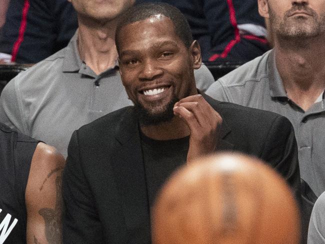 FILE - In this Nov. 1, 2019, file photo, Brooklyn Nets' Kyrie Irving, left, and Kevin Durant watch the game action from the bench during the second half of an NBA basketball game against the Houston Rockets in New York. With so much uncertainty around the NBA season, Brooklyn Nets general manager Sean Marks is no longer ruling Kevin Durant out for the season. Marks had repeatedly said he didn't expect Durant to play this season while recovering from Achilles tendon surgery, but he acknowledged Wednesday that everything is unknown now that the season is suspended because of the new coronavirus. Even Kyrie Irving, who had shoulder surgery on March 3, might be available if play stretched into the summer. (AP Photo/Mary Altaffer, File)