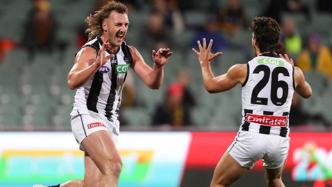 Lynden Dunn runs to teammate Josh Daicos to celebrate his goal.