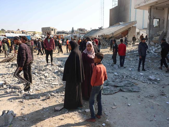 Palestinians check the damage following an Israeli strike which killed the Hamas police chief. Picture: AFP