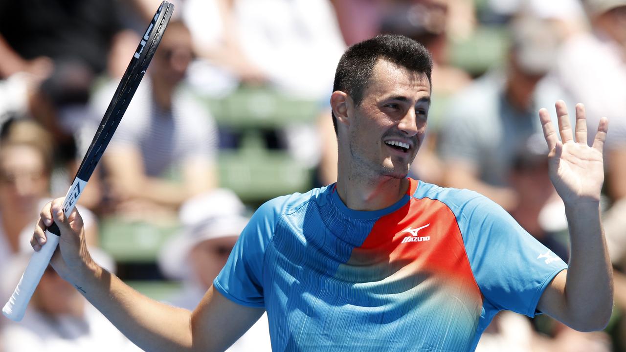 Bernard Tomic is all smiles in his match against Nick Kyrgios.